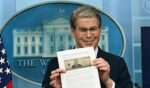 Treasury Secretary Scott Bessent shows a proposed $250 bill featuring President Donald Trump during a press briefing Thursday at the White House in Washington, D.C.