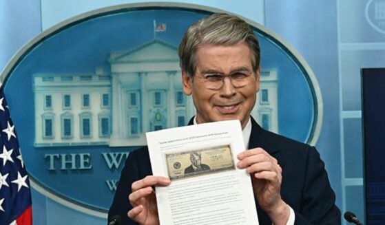 Treasury Secretary Scott Bessent shows a proposed $250 bill featuring President Donald Trump during a press briefing Thursday at the White House in Washington, D.C.