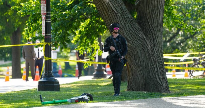 A U.S. Secret Service officer protects the crime scene following an exchange of gunfire Monday between Secret Service and a gunman on the National Mall in Washington, D.C. Police say a gunman shot at a Secret Service agent and wounded a bystander before being shot by police.