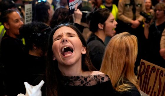 A woman protests outside the House chamber before a special session of the state legislature to redraw U.S. Congressional voting maps Thursday in Nashville, Tennessee.