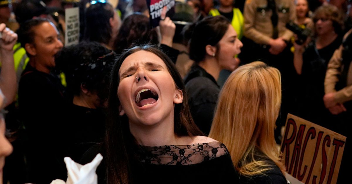 A woman protests outside the House chamber before a special session of the state legislature to redraw U.S. Congressional voting maps Thursday in Nashville, Tennessee.