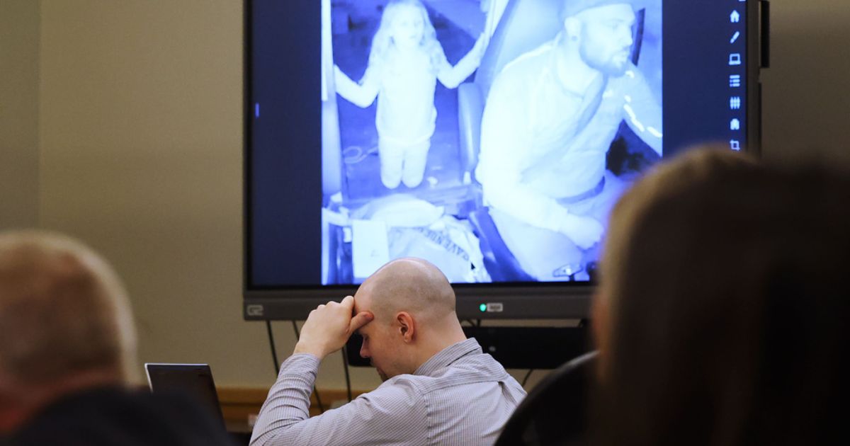 Defendant Tanner Horner reacts April 7 during testimony at the Tim Curry Criminal Justice Center in Fort Worth, Texas. Horner pleaded guilty to capital murder in the November 2022 strangulation killing of 7-year-old Athena Strand. The child is pictured in the video on the screen in the courtroom as Horner drives his FedEx truck.