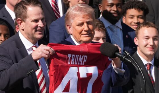 Indiana Hoosiers coach Curt Cignetti, left, presents President Donald Trump a jersey during an event to welcome the 2026 College Football Playoff national champions Indiana University on the South Lawn of the White House, Monday.