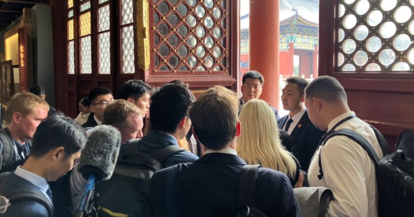 Members of the White House press pool are held by security members in a side room during President Donald Trump's visit to Temple of Heaven Thursday in Beijing, China. As an effort by Chinese officials to keep a tight hold of their American guests and dictate coverage of a global news event, U.S. reporters have been subject to strict controls.