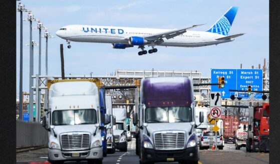 A United Airlines Boeing 767 passenger aircraft approaches Newark Liberty International Airport as trucks travel near the Port Newark Container Terminal in Newark, New Jersey, in a file photo dated April 8, 2025.