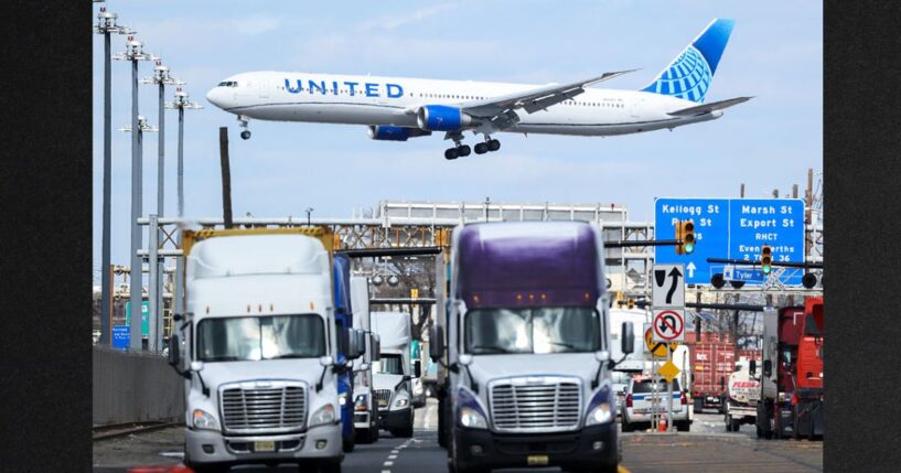 A United Airlines Boeing 767 passenger aircraft approaches Newark Liberty International Airport as trucks travel near the Port Newark Container Terminal in Newark, New Jersey, in a file photo dated April 8, 2025.