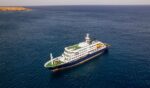 This aerial picture shows a general view of the cruise ship MV Hondius stationary off the port of Praia, the capital of Cape Verde, on May 3, 2026.