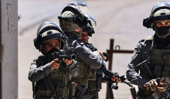 A member of the Israeli security forces aims his weapon while patrolling during a military raid in the Qalandia refugee camp, south of Ramallah in the Israeli-occupied West Bank, on May 11, 2026.