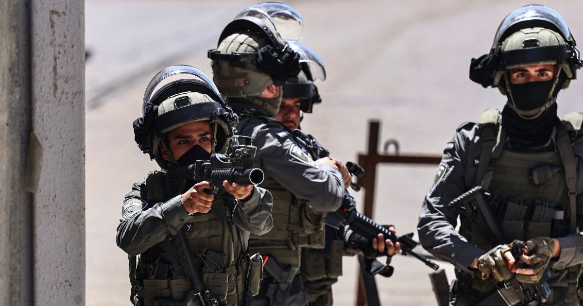 A member of the Israeli security forces aims his weapon while patrolling during a military raid in the Qalandia refugee camp, south of Ramallah in the Israeli-occupied West Bank, on May 11, 2026.