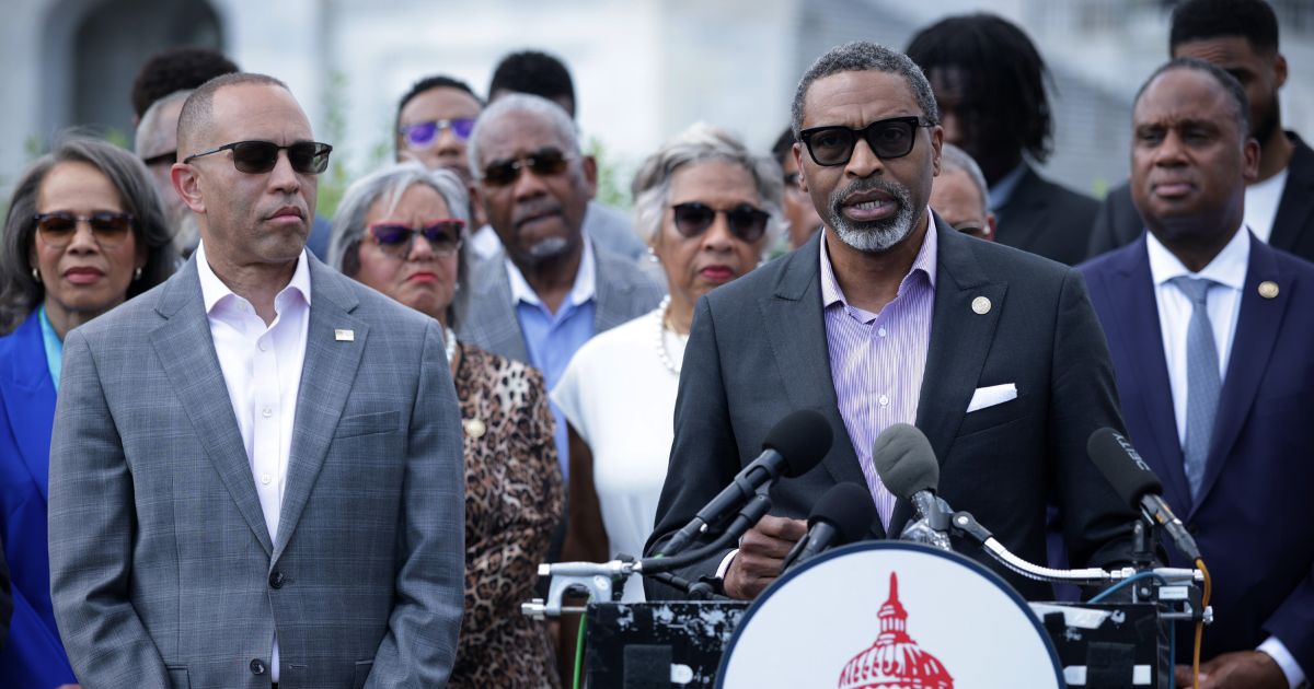 House Minority Leader Hakeem Jeffries looks on as NAACP President Derrick Johnson speaks during a news conference in opposition to the SCORE Act in front of the U.S. Capitol on May 19, 2026, in Washington, D.C.