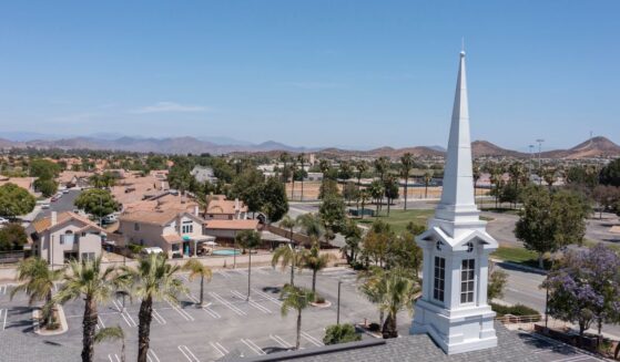 An aerial view of a sprawling single family home neighborhood and church in Menifee, California.