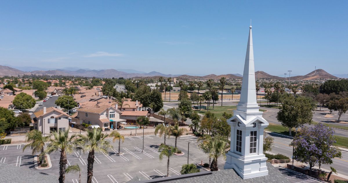 An aerial view of a sprawling single family home neighborhood and church in Menifee, California.