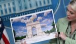 White House Press Secretary Karoline Leavitt shows an artist's rendering of President Donald Trump's planned Triumphal Arch during a press briefing in the Brady Briefing Room at the White House in Washington, D.C., on April 15, 2026.