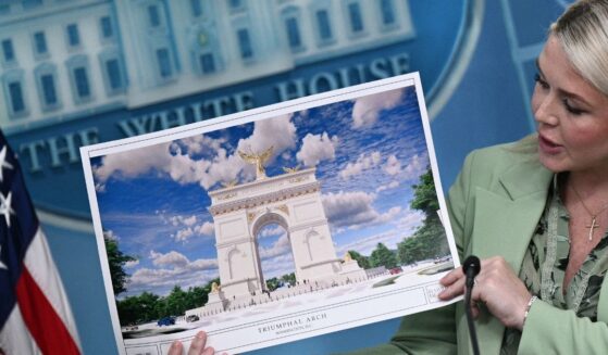 White House Press Secretary Karoline Leavitt shows an artist's rendering of President Donald Trump's planned Triumphal Arch during a press briefing in the Brady Briefing Room at the White House in Washington, D.C., on April 15, 2026.