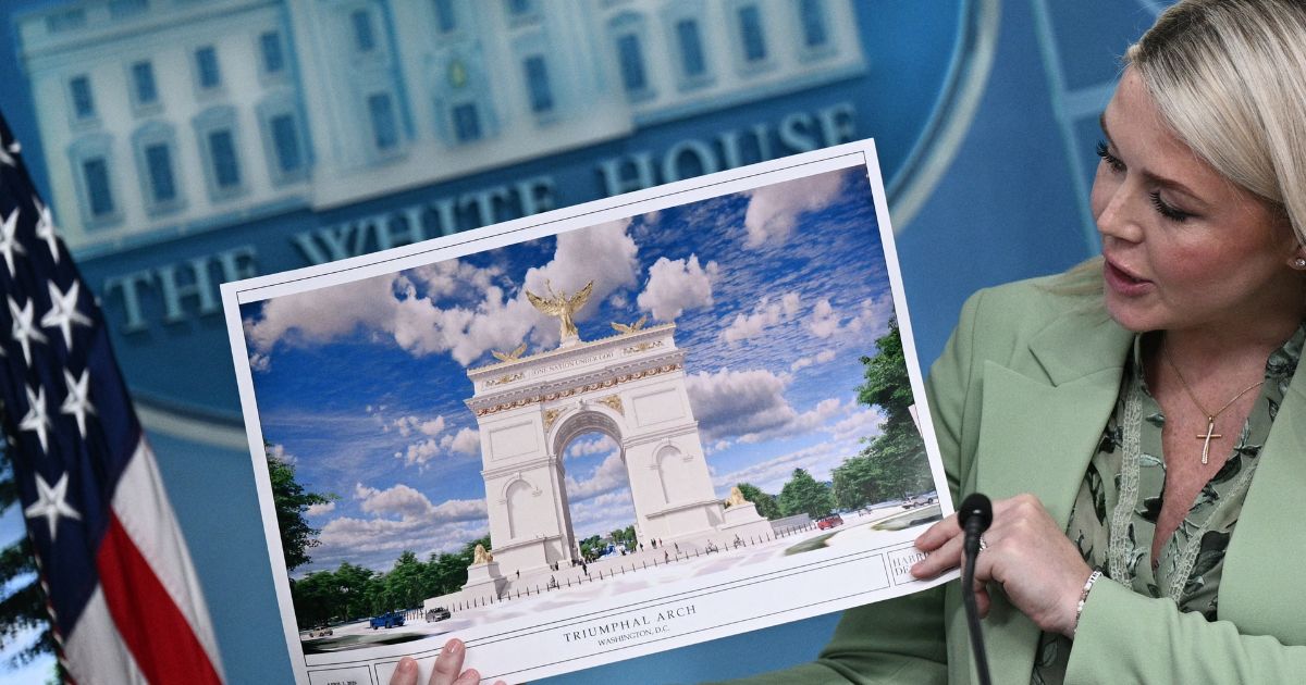 White House Press Secretary Karoline Leavitt shows an artist's rendering of President Donald Trump's planned Triumphal Arch during a press briefing in the Brady Briefing Room at the White House in Washington, D.C., on April 15, 2026.