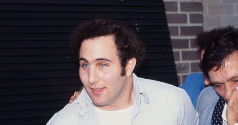 Police officers escort accused and ultimately convicted serial killer David Berkowitz, known as the Son of Sam, into the 84th precinct station in New York on Aug. 10, 1977.