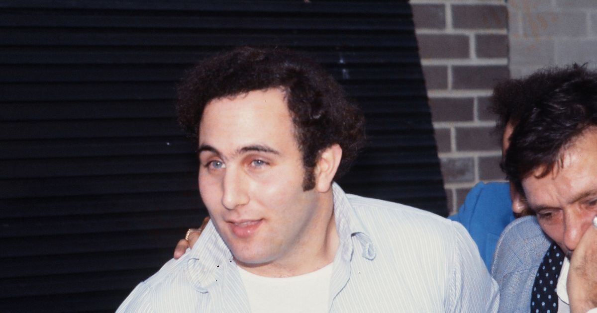Police officers escort accused and ultimately convicted serial killer David Berkowitz, known as the Son of Sam, into the 84th precinct station in New York on Aug. 10, 1977.