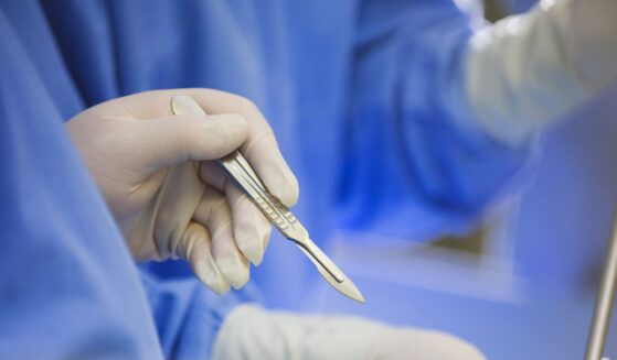 A surgeon using a scalpel during surgery.