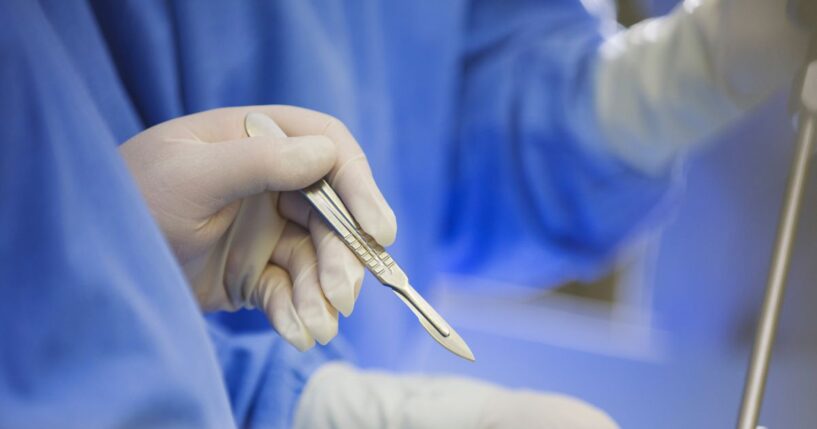 A surgeon using a scalpel during surgery.