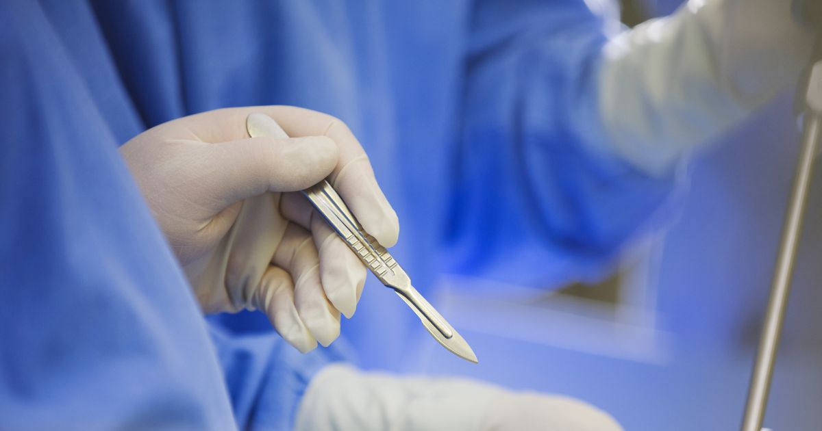 A surgeon using a scalpel during surgery.