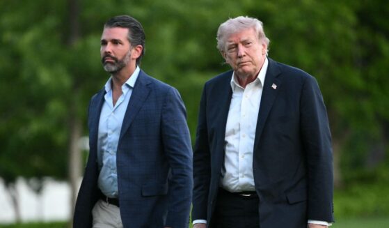 President Donald Trump and Donald Trump Jr. walk on the south lawn toward the White House in Washington, D.C., on May 3, 2026.