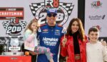 Kyle Busch celebrates with daughter, Lennix Busch, son, Brexton Busch, and wife, Samantha Busch in victory lane after winning the NASCAR Craftsman Truck Series Fr8 Racing 208 at Echo Park Speedway on Feb. 21, 2026, in Hampton, Georgia.