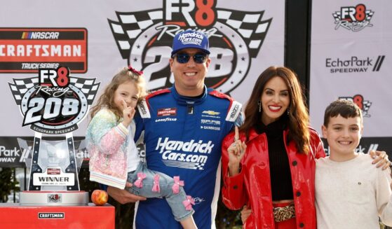 Kyle Busch celebrates with daughter, Lennix Busch, son, Brexton Busch, and wife, Samantha Busch in victory lane after winning the NASCAR Craftsman Truck Series Fr8 Racing 208 at Echo Park Speedway on Feb. 21, 2026, in Hampton, Georgia.
