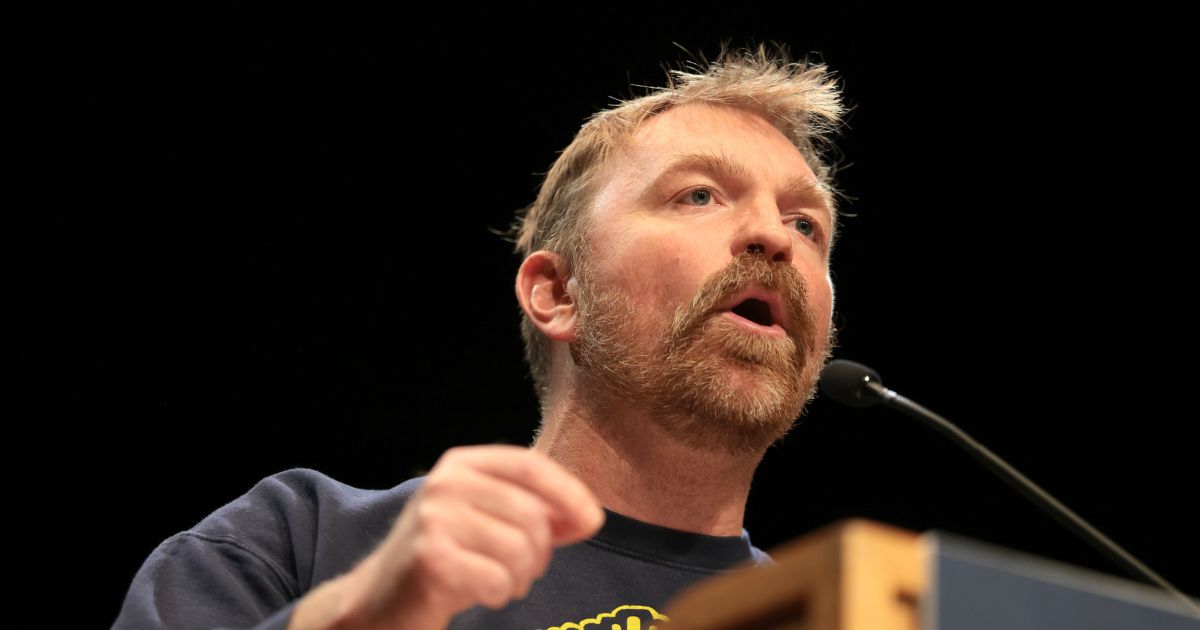 Democratic Senate candidate Graham Platner speaks at a “Fighting Oligarchy” tour stop held by Sen. Bernie Sanders at the Collins Center for the Arts on the University of Maine campus on May 24, 2026, in Orono, Maine.