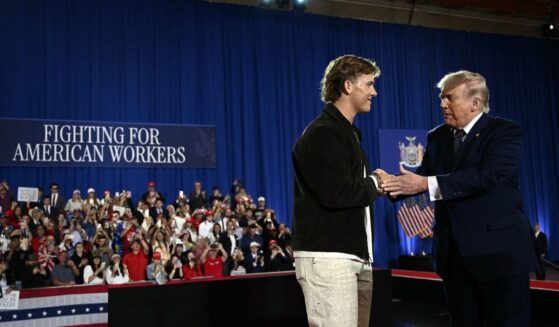 President Donald Trump is welcomed by New York Giants quarterback Jaxson Dart before delivering a speech about the economy at Rockland Community College Fieldhouse in Suffern, New York, on May 22, 2026.