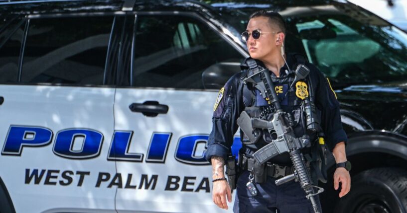 A police officer stands watch outside the Paul G. Rogers Federal Building and U.S. Courthouse during a hearing on the detention of Ryan Wesley Routh, suspected of the attempted assassination of President Donald Trump, in West Palm Beach, Florida, on Sept. 30, 2024.