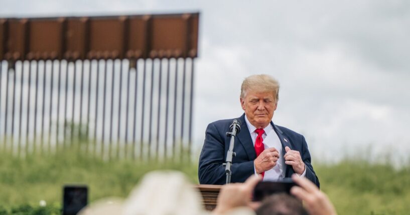 President Donald Trump pulls out his notes before speaking during a tour to an unfinished section of the border wall on June 30, 2021, in Pharr, Texas.