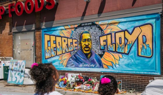 Jordan and Royal Pacheco learn of George Floyd's murder at the intersection of 38th Street and Chicago Avenue, ahead of former Minneapolis police officer Derek Chauvin's sentencing, on June 25, 2021, in Minneapolis, Minnesota.