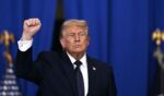 President Donald Trump raises a fist as he departs after delivering a speech about the economy at Rockland Community College Fieldhouse in Suffern, New York, on May 22, 2026.