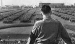 German Fuhrer and Nazi leader Adolf Hitler addresses soldiers with his back facing the camera at a Nazi rally in Dortmund, Germany.