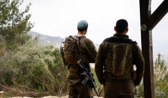 Israeli soldiers take a position along the Israel-Lebanon border on March 7, 2026.