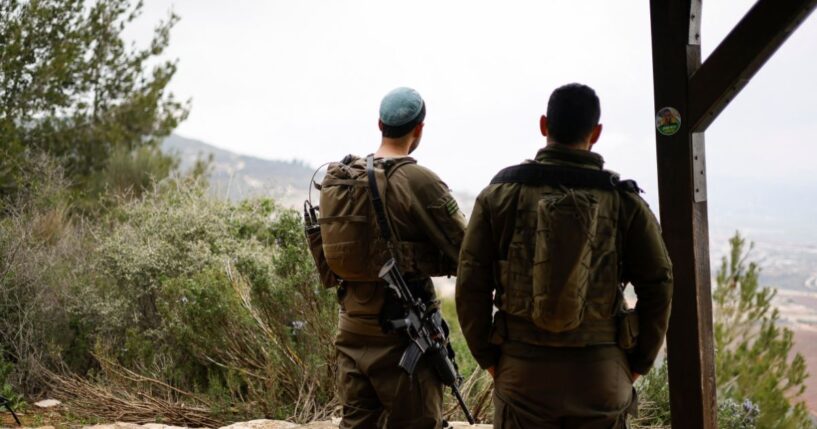 Israeli soldiers take a position along the Israel-Lebanon border on March 7, 2026.