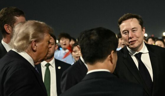 President Donald Trump presents SpaceX, Twitter and electric car maker Tesla CEO Elon Musk to China's Vice President Han Zheng at Beijing Capital Airport in Beijing on May 13, 2026.