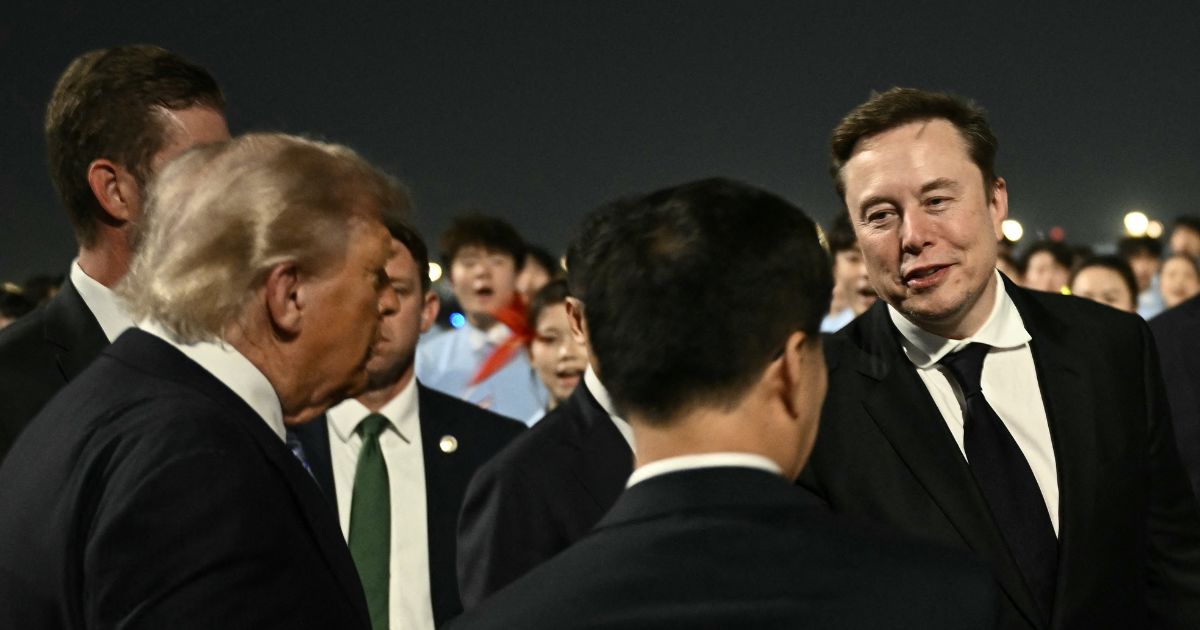 President Donald Trump presents SpaceX, Twitter and electric car maker Tesla CEO Elon Musk to China's Vice President Han Zheng at Beijing Capital Airport in Beijing on May 13, 2026.