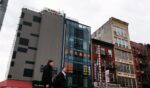 People walk by a building suspected of being used as a secret police station in Chinatown for the purpose of repressing dissidents living in the United States on behalf of the Chinese government in lower Manhattan on April 18, 2023, in New York City.