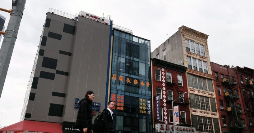 People walk by a building suspected of being used as a secret police station in Chinatown for the purpose of repressing dissidents living in the United States on behalf of the Chinese government in lower Manhattan on April 18, 2023, in New York City.