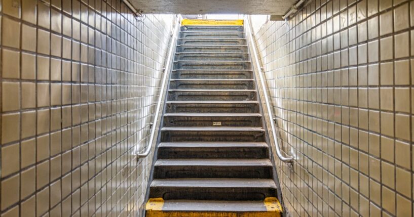 Stairs leading up to the street from an underground subway station in New York City.