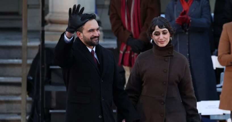 New York City Mayor Zohran Mamdani waves next to his wife Rama Duwaji during his public inauguration ceremony followed by a block party at City Hall in New York on Jan. 1, 2026.