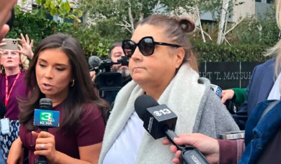 Dana Williamson, a former chief of staff to Gov. Gavin Newsom, center, leaves the federal courthouse in Sacramento, California, surrounded by reporters in a Nov. 12 file photo.