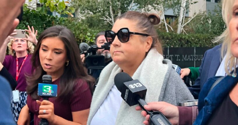 Dana Williamson, a former chief of staff to Gov. Gavin Newsom, center, leaves the federal courthouse in Sacramento, California, surrounded by reporters in a Nov. 12 file photo.