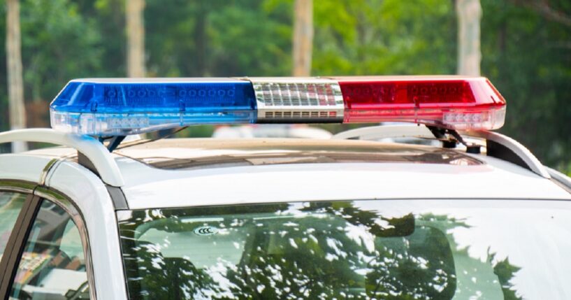 A law enforcement vehicle with lights flashing.