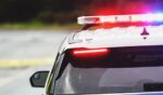 A stock image of a police car with flashing lights.
