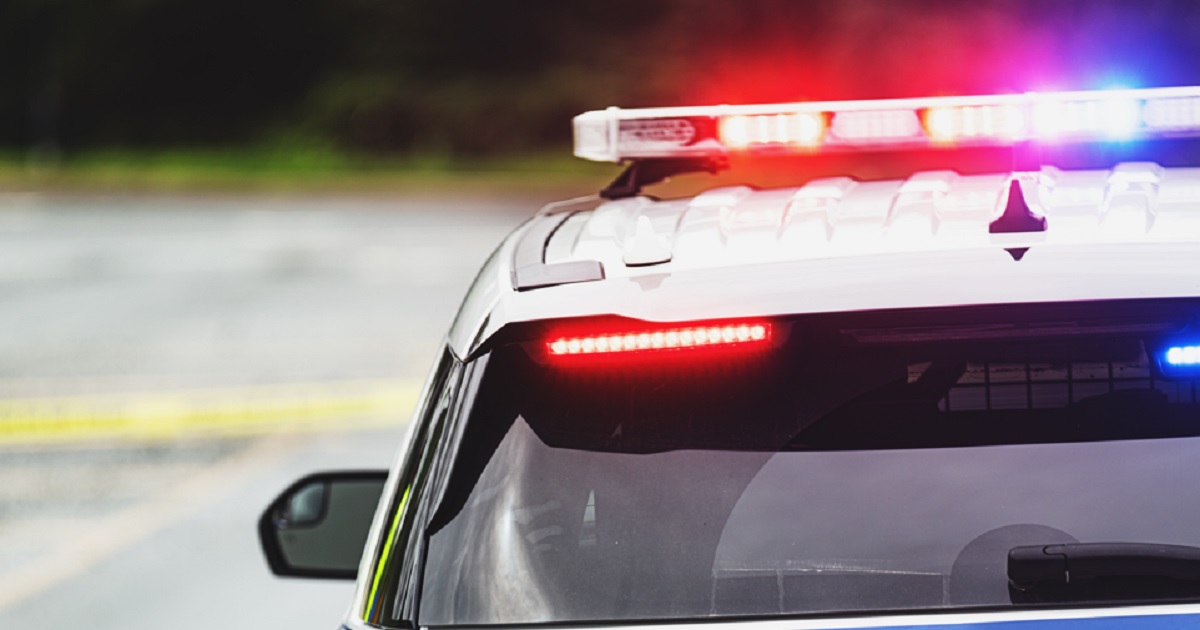 A stock image of a police car with flashing lights.