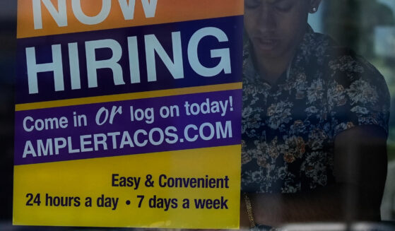A hiring sign is displayed at a restaurant in Niles, Illinois, on May 14, 2026.
