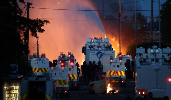 Police use a water cannon Wednesday as they block the road from protesters in Glengormley, north of Belfast, Northern Ireland.