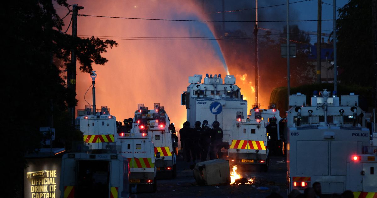 Police use a water cannon Wednesday as they block the road from protesters in Glengormley, north of Belfast, Northern Ireland.